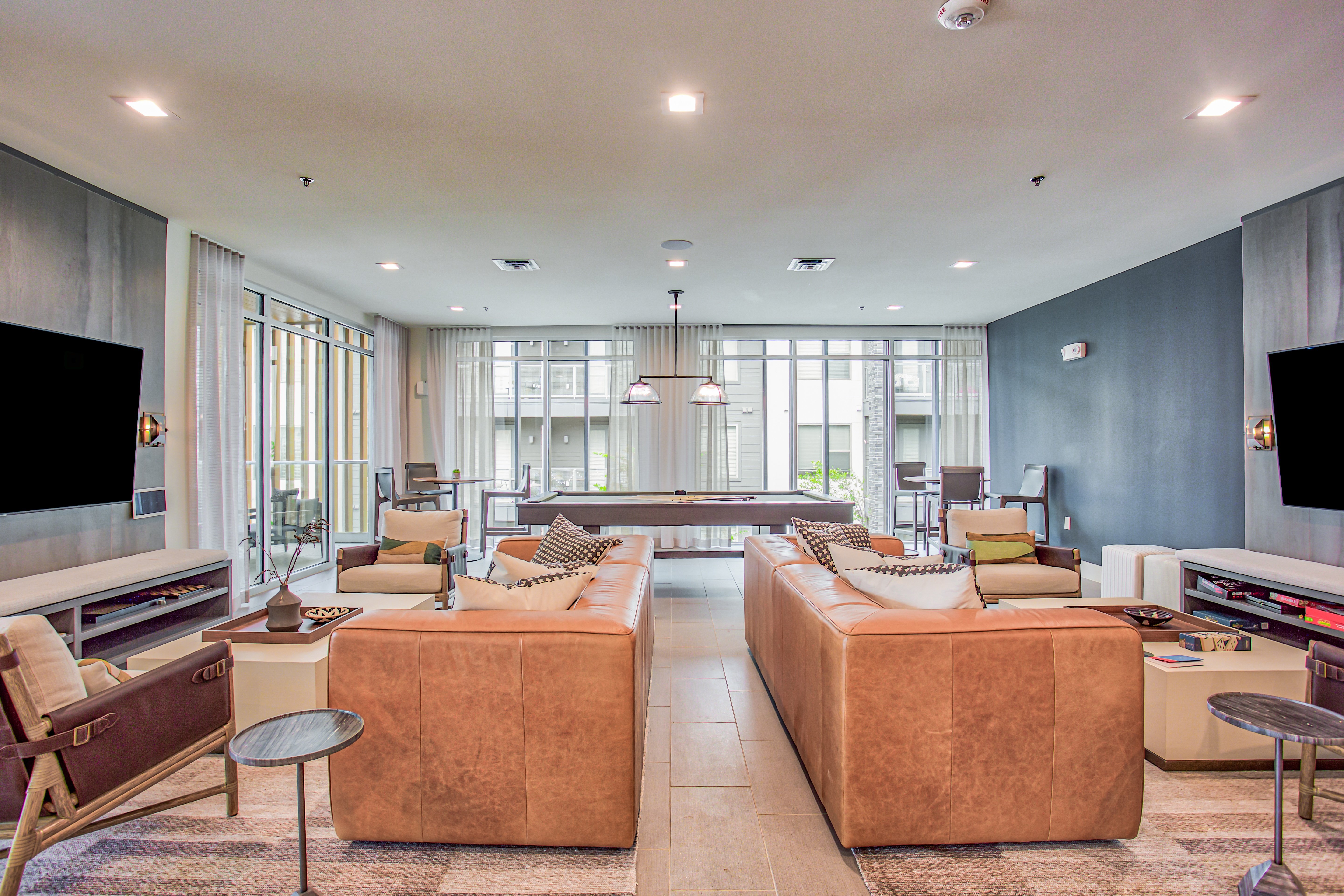 a living room with couches and chairs and a television